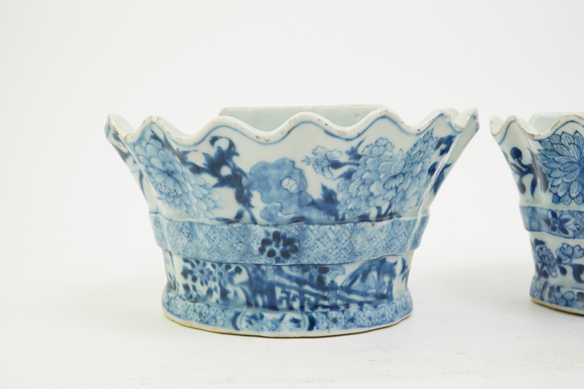 A pair of unusual Chinese export blue and white bough pots, after a Delft model, Qianlong period